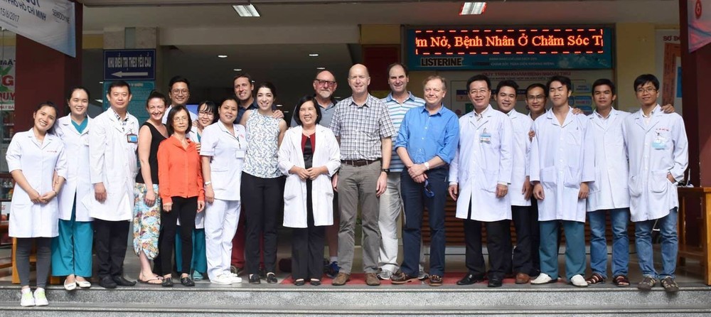 Team members with hospital oral and maxillofacial surgery staff